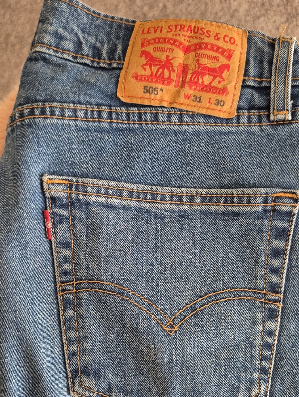 Levi's blue denim 505 straight jeans with tan leather patch